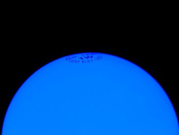 Close-up of blue ball against black background