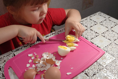 High angle view of girl holding food at home