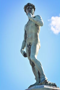 Low angle view of statue against blue sky