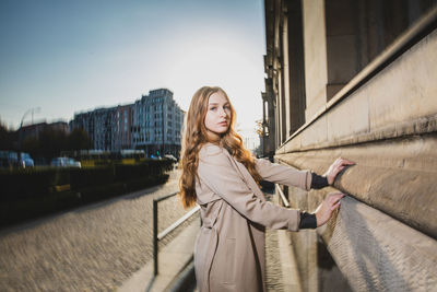 Portrait of young woman in city