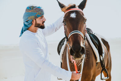 Man with horse on desert