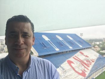 Portrait of man smiling against sky