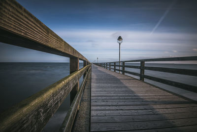 Pier over sea against sky