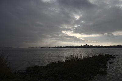 Scenic view of sea against sky at dusk