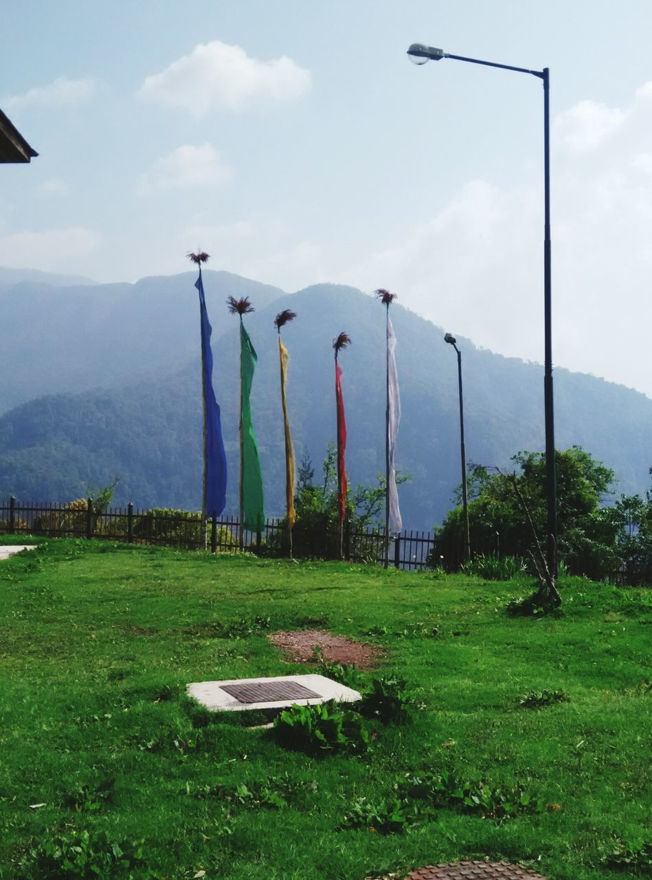 mountain, sky, grass, mountain range, landscape, tranquility, tranquil scene, cloud - sky, nature, field, scenics, green color, cloud, beauty in nature, plant, non-urban scene, day, grassy, no people, hill