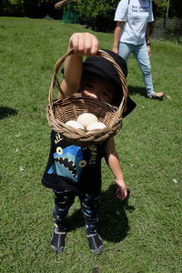 Low section of father and son playing on grassy field