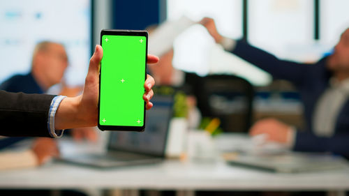 Man using mobile phone on table