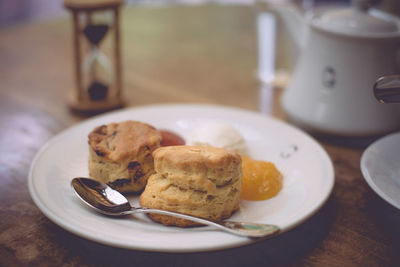 Close-up of scones in plate on table