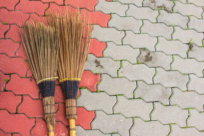 High angle view of brooms on footpath