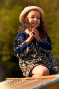 Portrait of cute girl holding hat