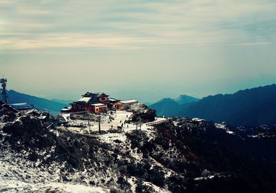 Scenic view of mountains against cloudy sky