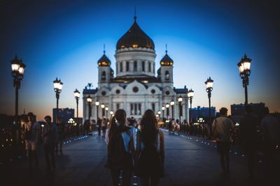 People visiting cathedral of christ the saviour against sky at dusk