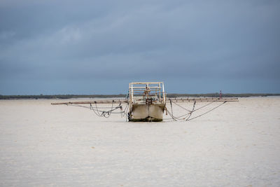 Lifeguard hut on beach against sky