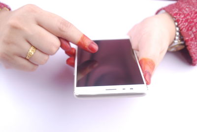 Midsection of woman using mobile phone