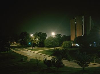 Illuminated city against sky at night