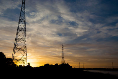 Silhouette of communications tower at sunset