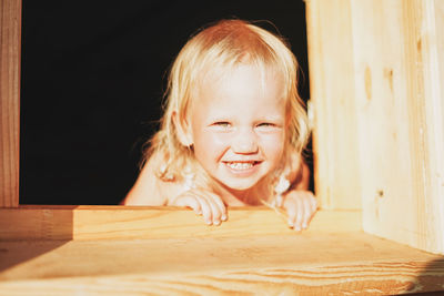 Portrait of cute girl smiling on table