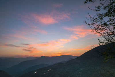 Scenic view of silhouette mountains against sky during sunset