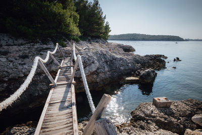 Scenic view of sea and bridge against sky