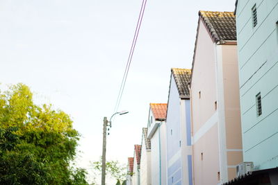 Low angle view of houses against clear sky