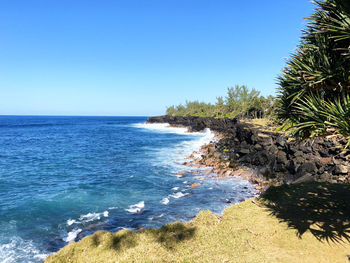 Scenic view of sea against clear blue sky