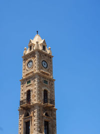 Low angle view of building against clear blue sky