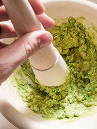 Close-up of person preparing food in plate