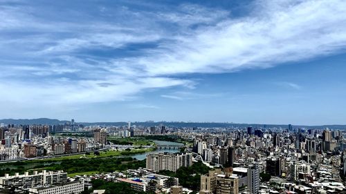High angle view of city buildings against sky