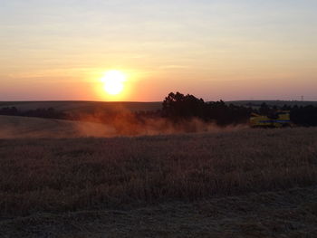 Scenic view of field against sky during sunset