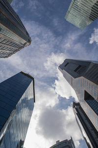 Low angle view of buildings against cloudy sky