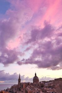 Cityscape against sky at sunset