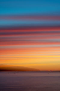 Scenic view of sea against orange sky