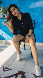 Full length portrait of young woman in swimming pool