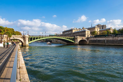 Arch bridge over river against sky