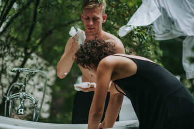 Rear view of couple looking at camera