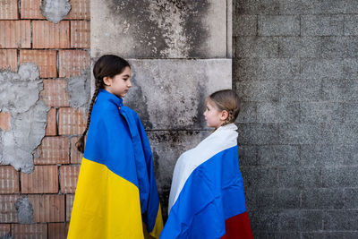 Girls with flags against wall