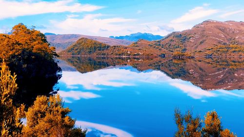 Scenic view of trees and mountains against sky