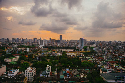 Aerial view of buildings in city against sky