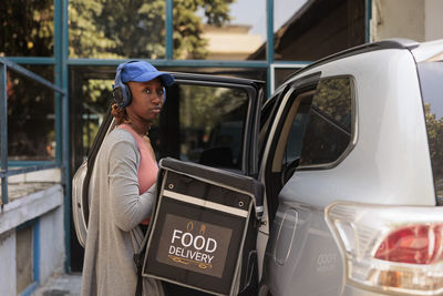 Side view of young woman in car