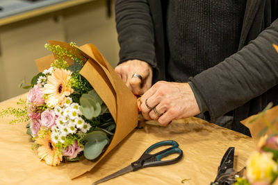 Midsection of woman holding bouquet