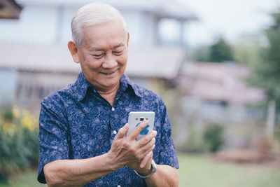 Mid adult man using mobile phone