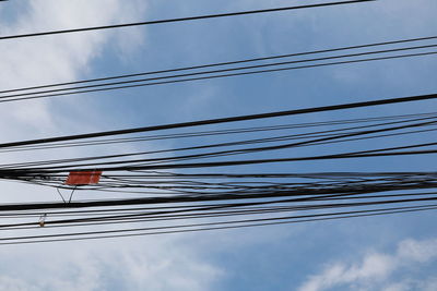 Low angle view of cables against sky