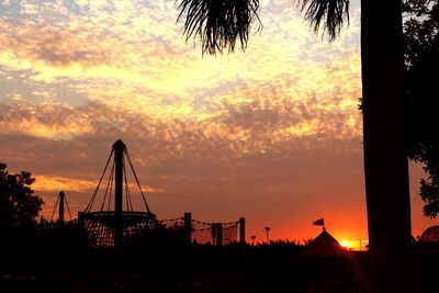 Silhouette of palm trees against sky during sunset