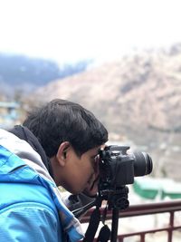 Portrait of boy photographing