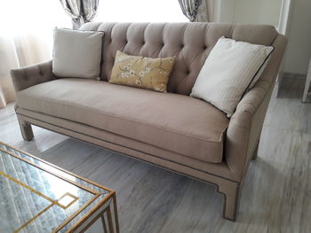 High angle view of light brown sofa three seater at living room home