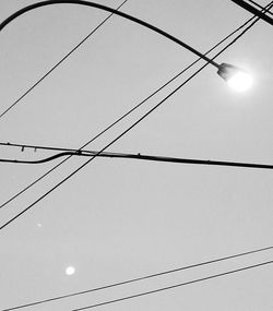 Low angle view of electricity pylon against sky