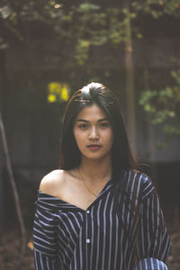 Portrait of young woman standing outdoors