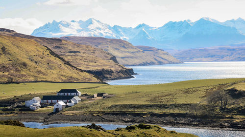 Scenic view of lake and mountains against sky