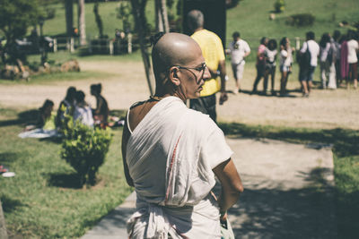 Rear view of men standing in park