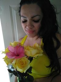 Close-up of young woman with red roses